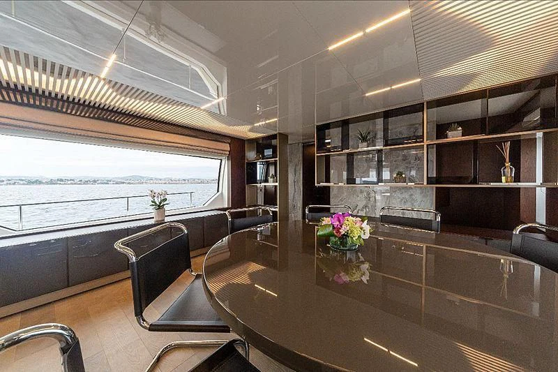 a large room with a table and chairs aboard GIO 2 Yacht for Sale