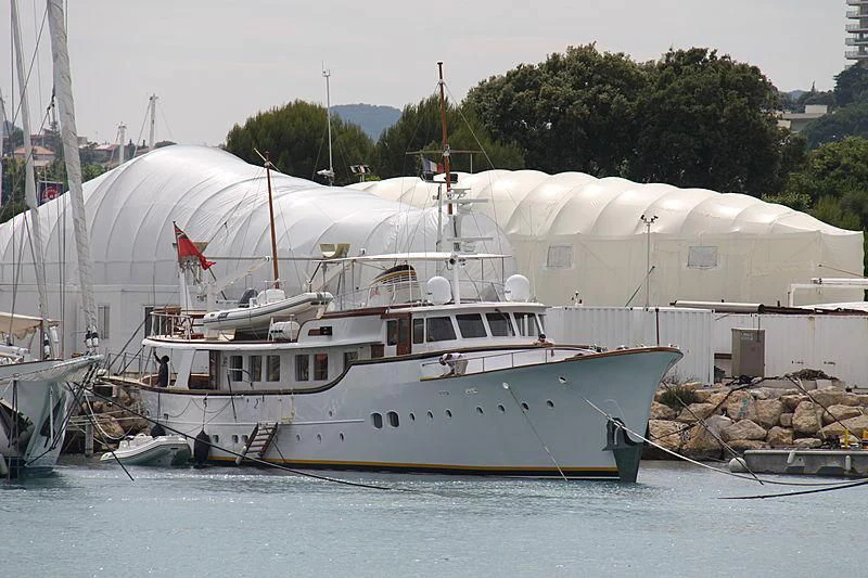 a large white boat in a harbor aboard BLUE ALBACOR Yacht for Sale