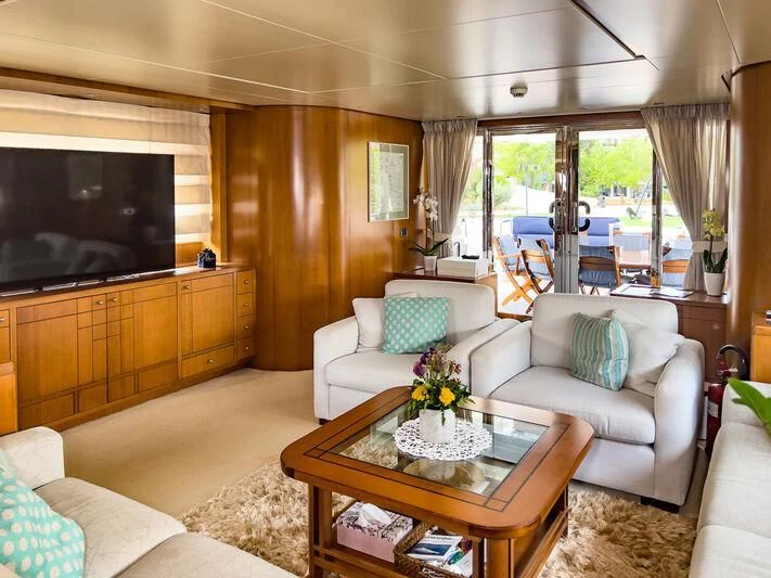 a living room with a large television aboard AMNA Yacht for Sale