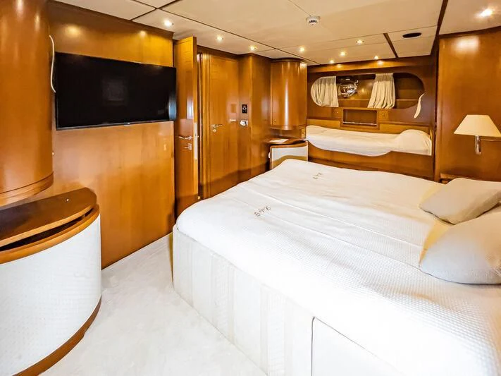 a room with a bed and a tv aboard AMNA Yacht for Sale