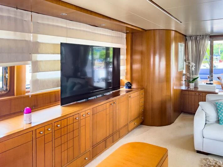 a room with a tv and a couch aboard AMNA Yacht for Sale