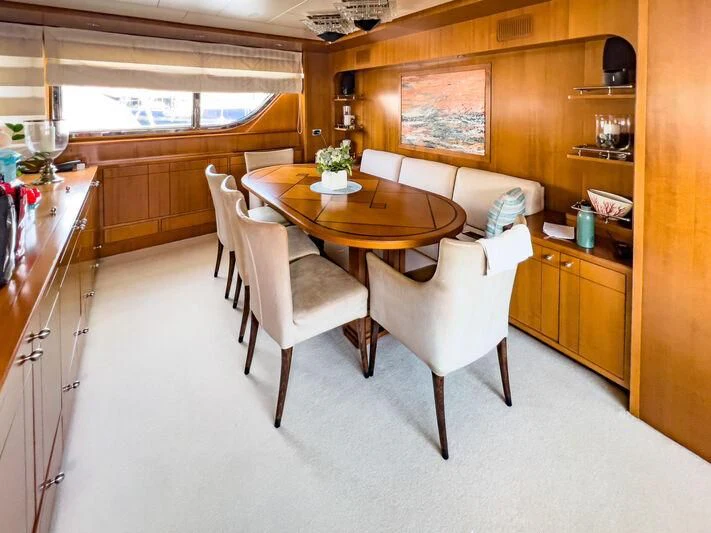 a table and chairs in a room aboard AMNA Yacht for Sale