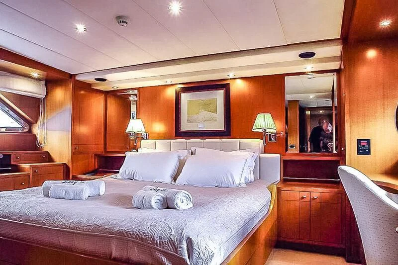 a bed with a white pillow on it aboard AMNA Yacht for Sale
