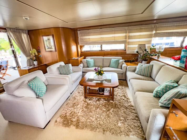 a living room with a couch and a coffee table aboard AMNA Yacht for Sale