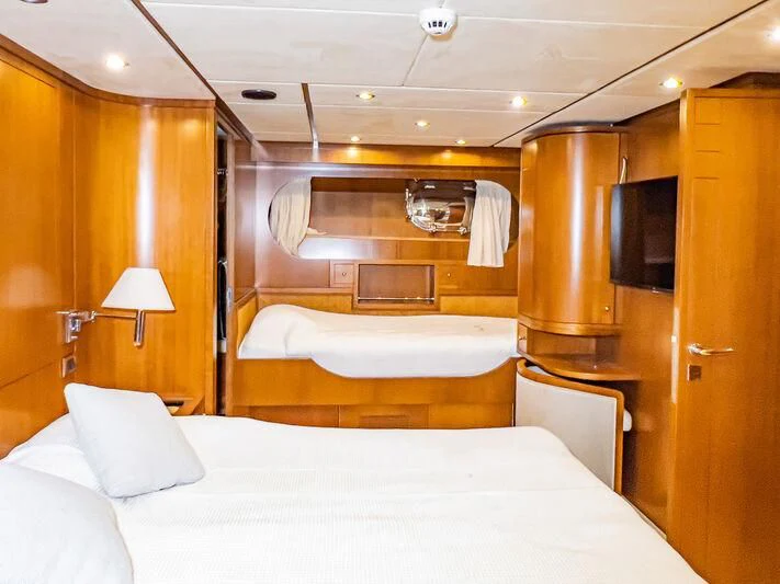 a hotel room with a bed and a television aboard AMNA Yacht for Sale