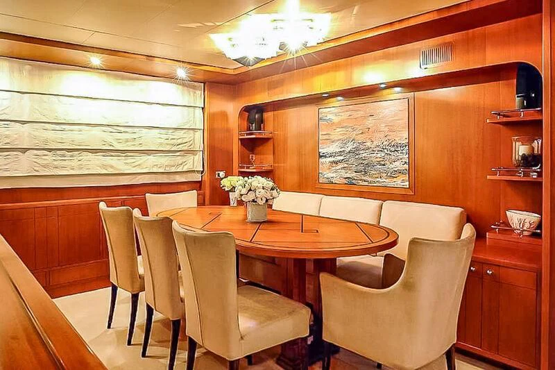 a room with a table chairs and a window aboard AMNA Yacht for Sale
