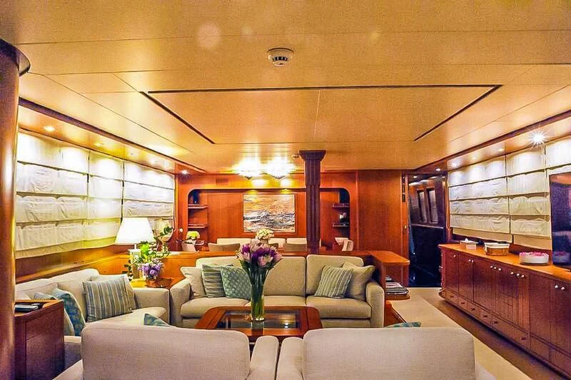 a living room with a couch and a table aboard AMNA Yacht for Sale