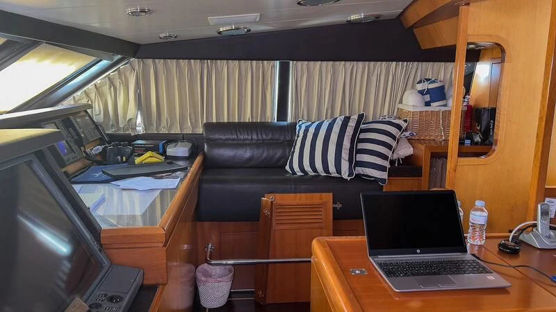 a laptop on a table aboard AMNA Yacht for Sale