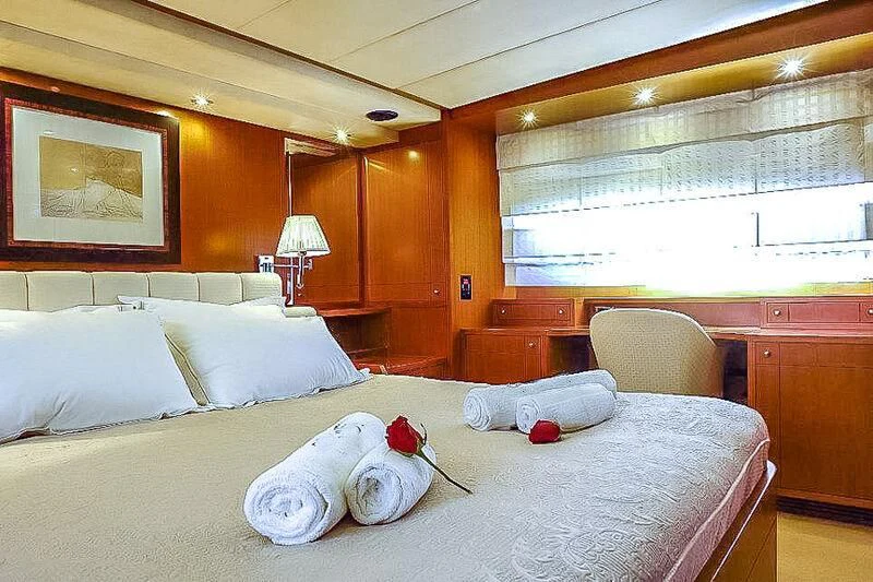 a bedroom with a bed and a chair aboard AMNA Yacht for Sale