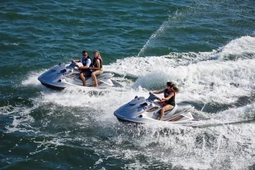 a group of people on a jet ski in the ocean aboard CHANTAL MA VIE Yacht for Sale