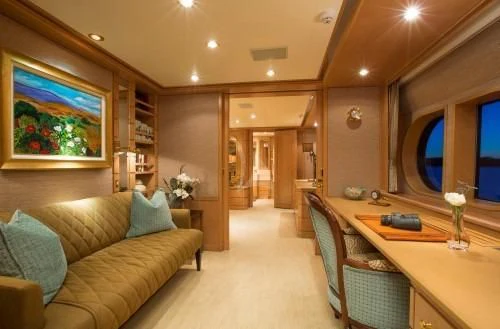 a living room with a couch and a table aboard CHANTAL MA VIE Yacht for Sale