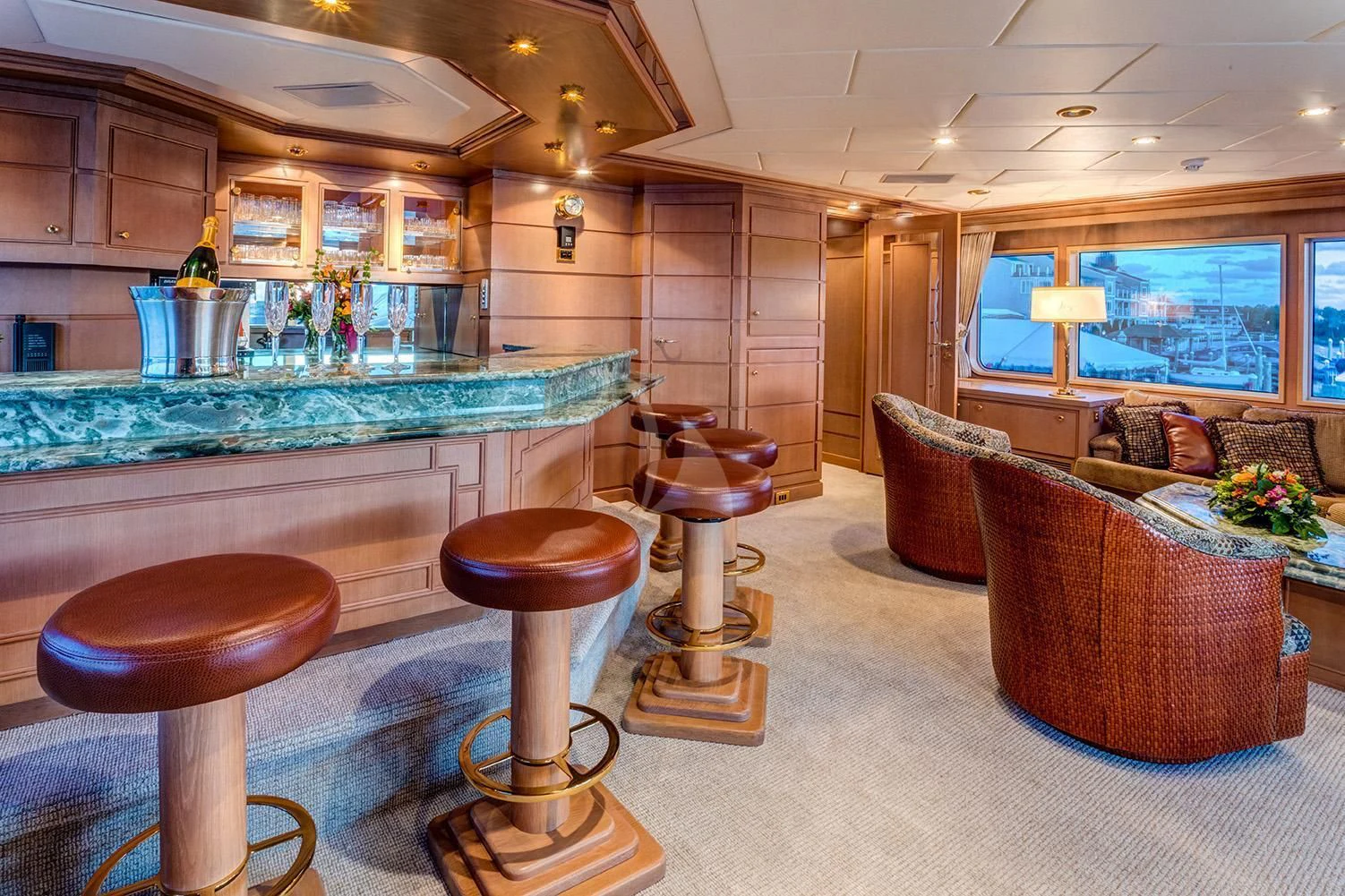 a large kitchen with a bar and bar stools aboard CHANTAL MA VIE Yacht for Sale