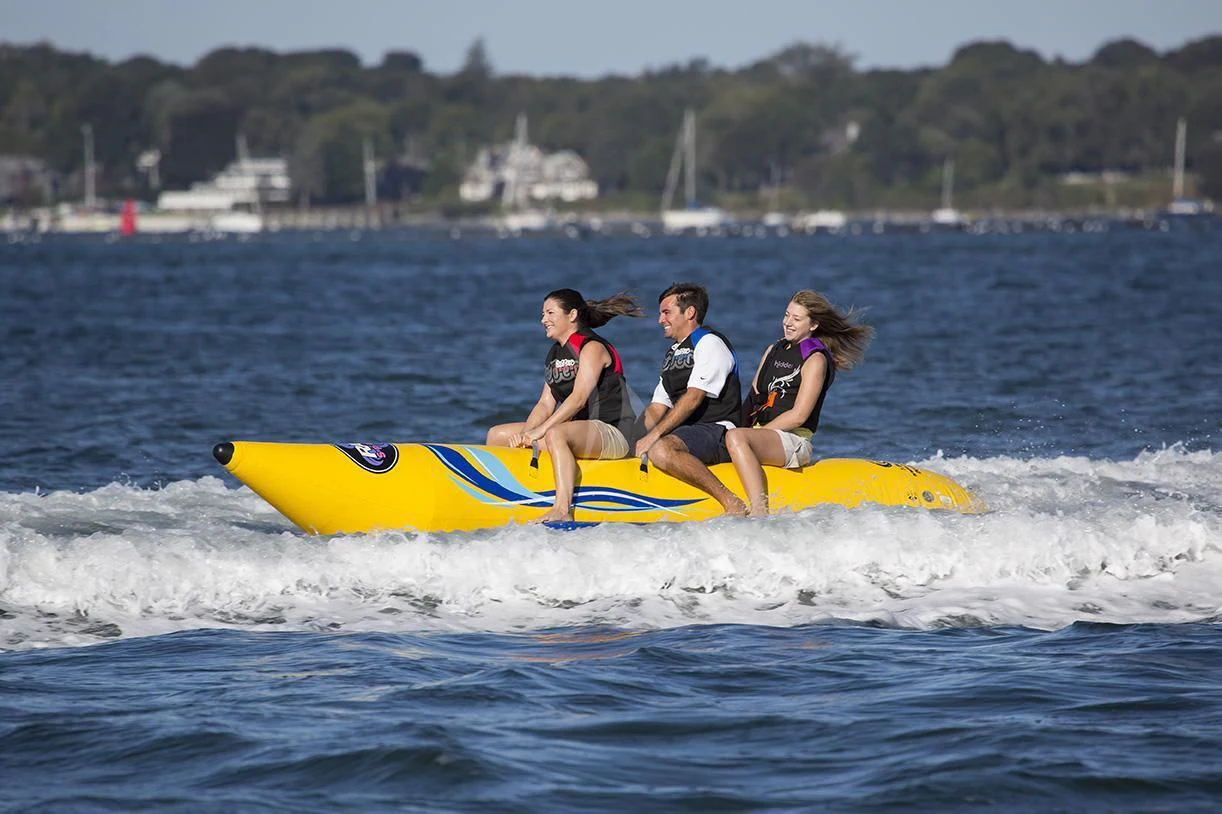 a group of people on a yellow surfboard in the water aboard CHANTAL MA VIE Yacht for Sale