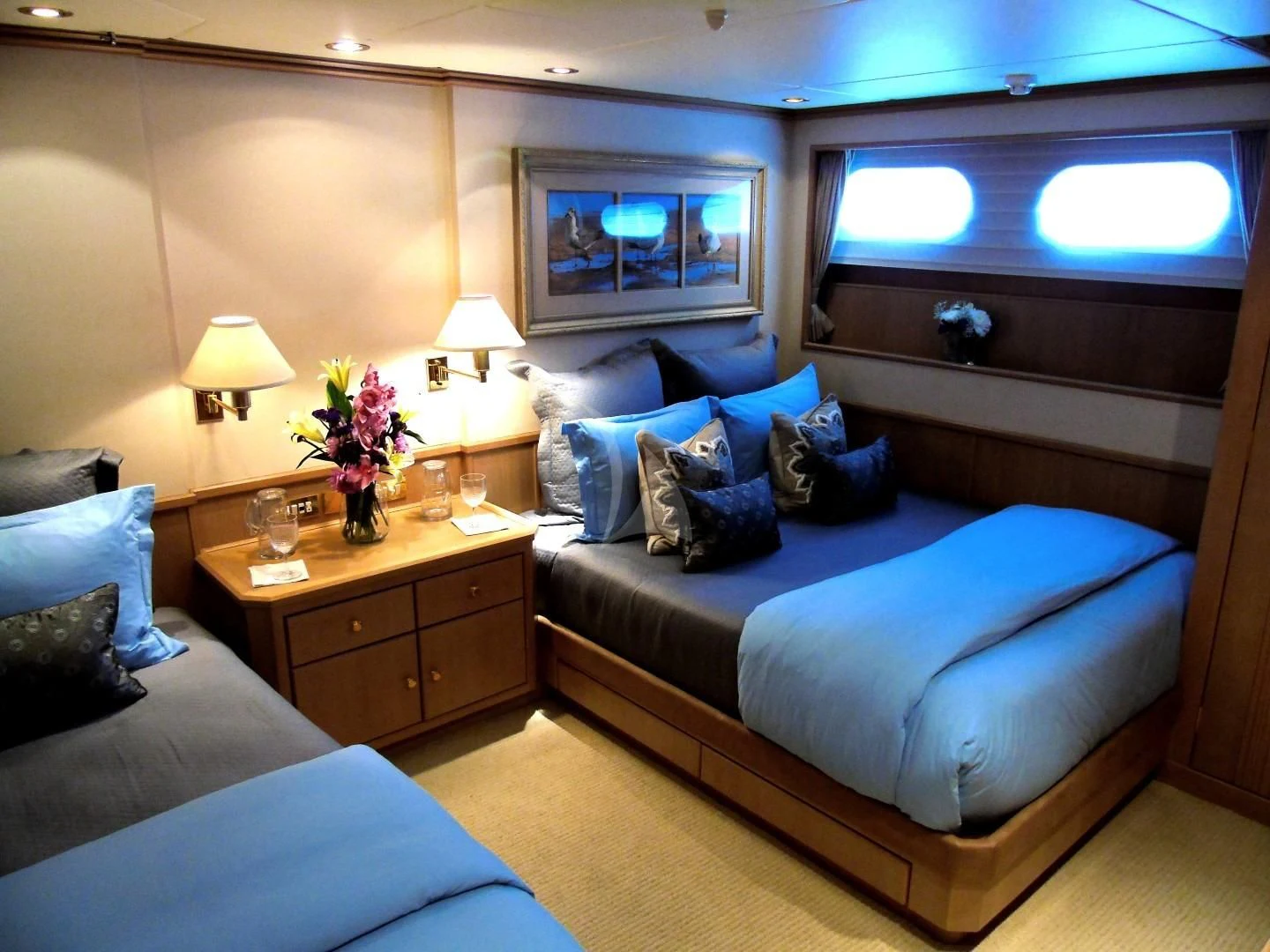 a bed with blue sheets aboard CHANTAL MA VIE Yacht for Sale
