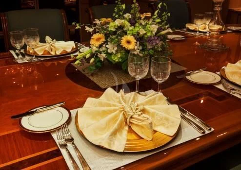 a table with plates and glasses of wine aboard CHANTAL MA VIE Yacht for Sale