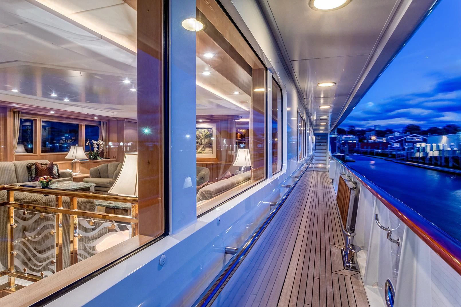 a deck with a view of a city at night aboard CHANTAL MA VIE Yacht for Sale