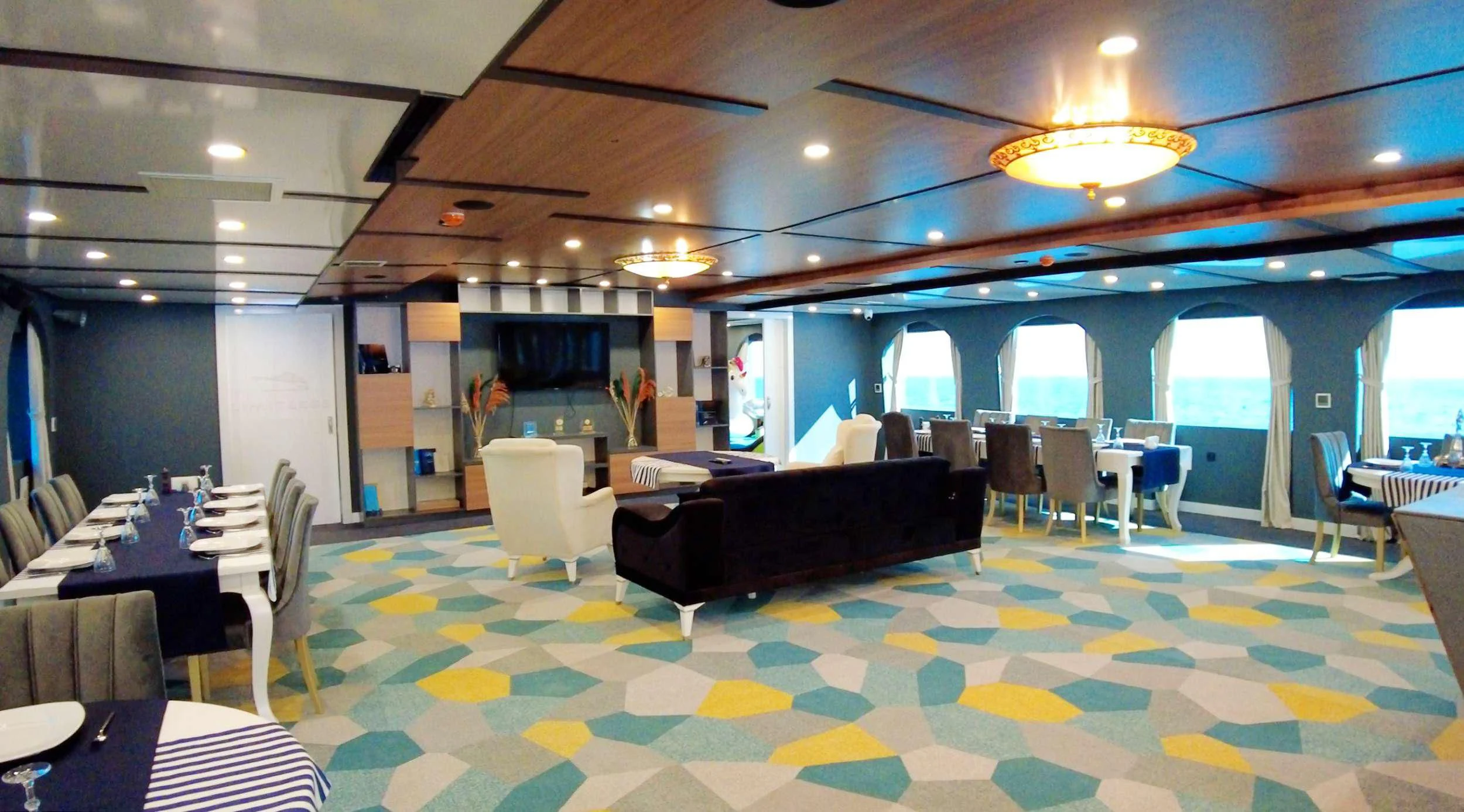 a large room with a couch and chairs aboard LIMITLESS Yacht for Charter