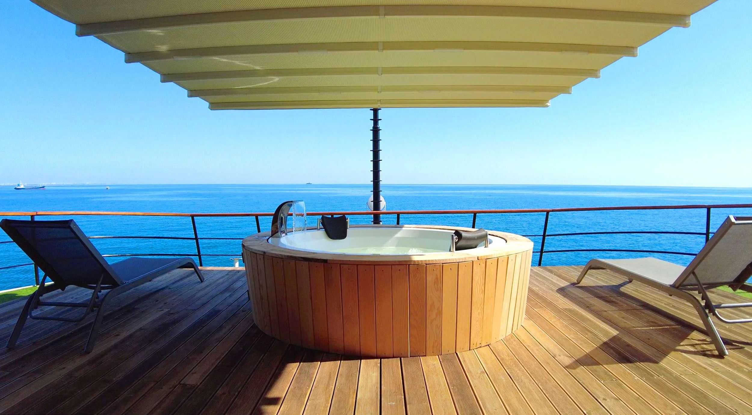 a table on a deck overlooking the ocean aboard LIMITLESS Yacht for Charter