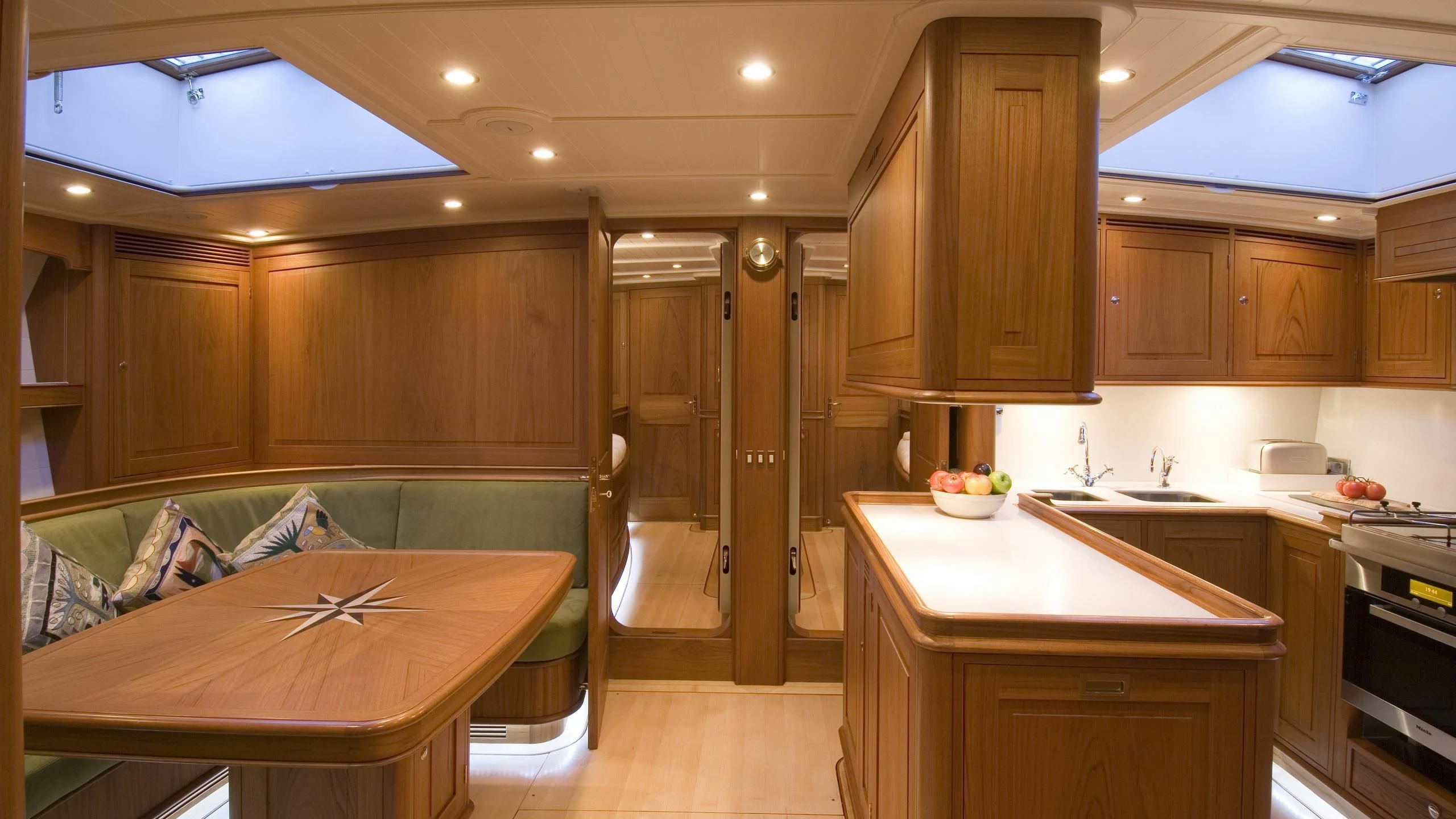 a kitchen with a bed and a couch aboard VELACARINA Yacht for Sale