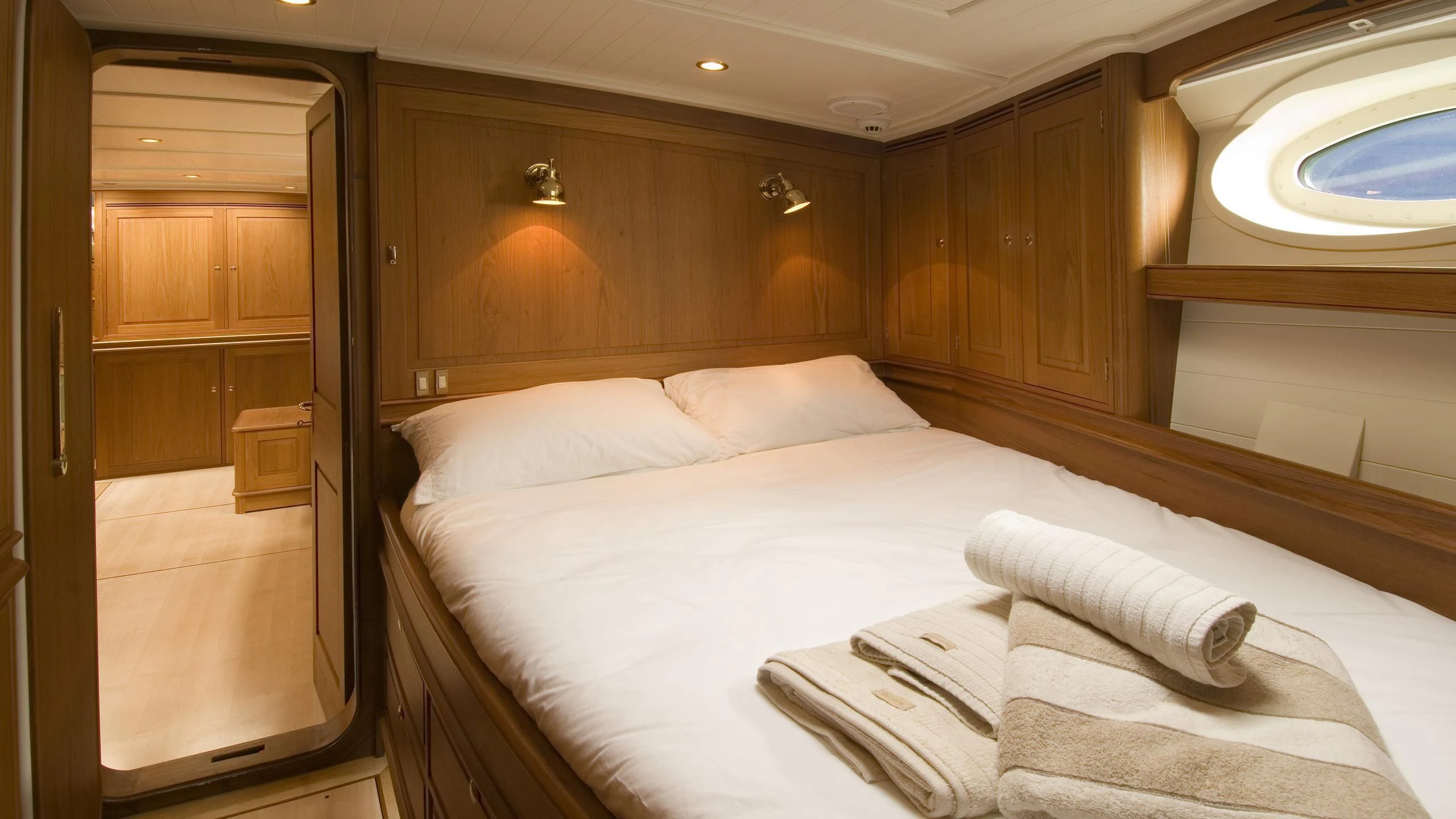 a bed with white sheets aboard VELACARINA Yacht for Sale