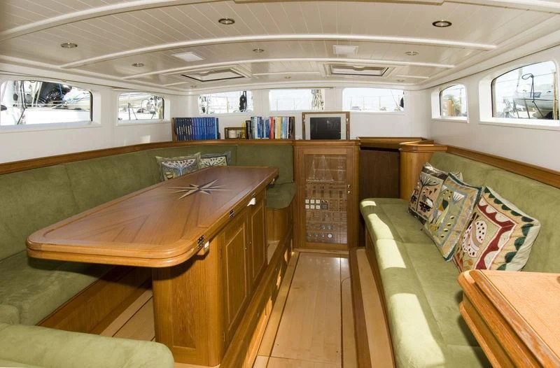 a room with a table and couches aboard VELACARINA Yacht for Sale