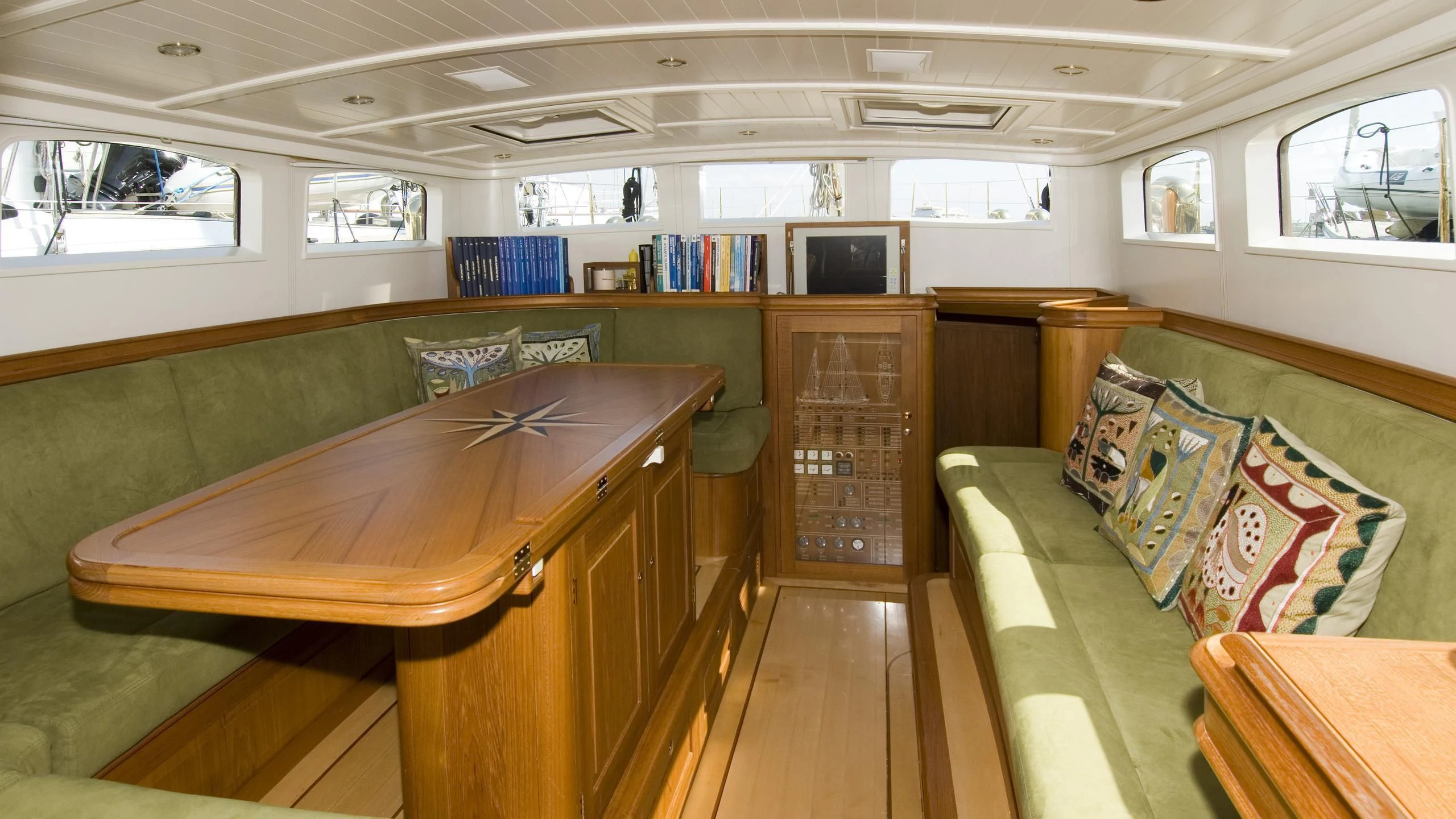 a room with a table and couch aboard VELACARINA Yacht for Sale