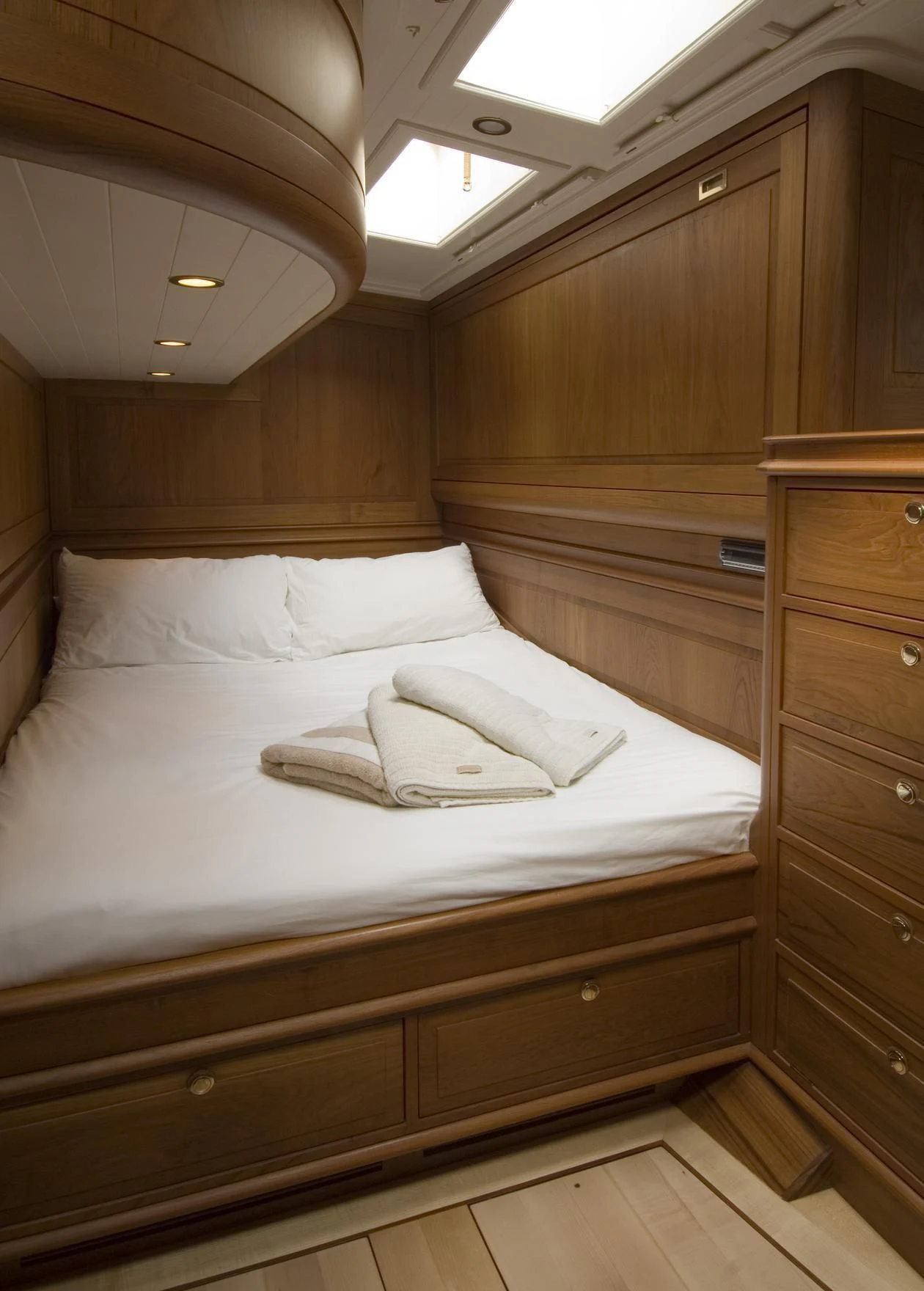a bed with white sheets aboard VELACARINA Yacht for Sale