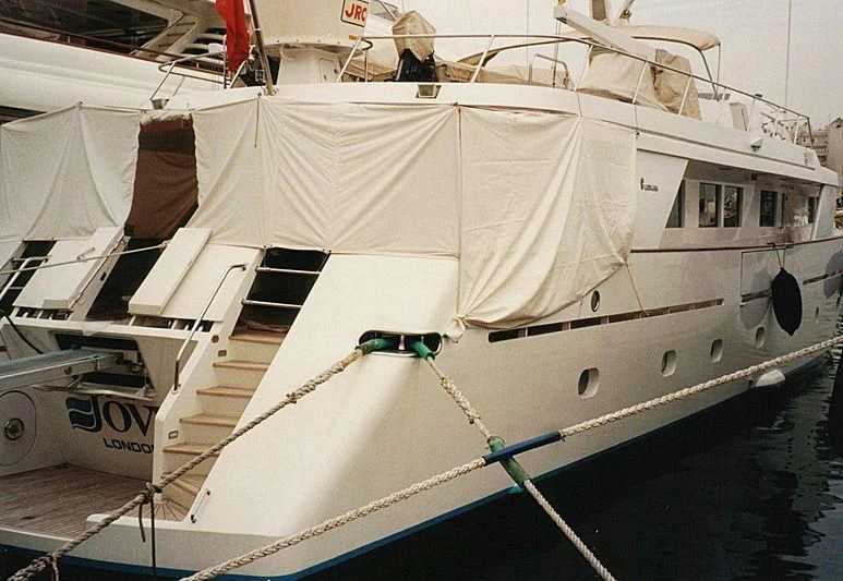 a white boat with a red stripe aboard IOVY Yacht for Sale