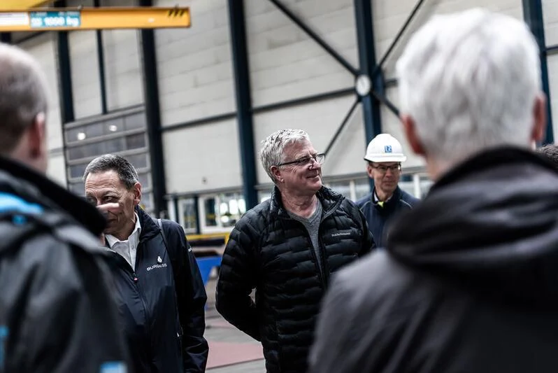 a group of men standing outside a building aboard DAMEN YACHTING CUSTOM HYBRID 75 Yacht for Sale