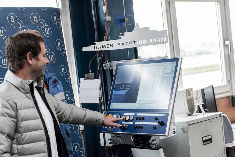 a person in a suit looking at a computer screen aboard DAMEN YACHTING CUSTOM HYBRID 75 Yacht for Sale