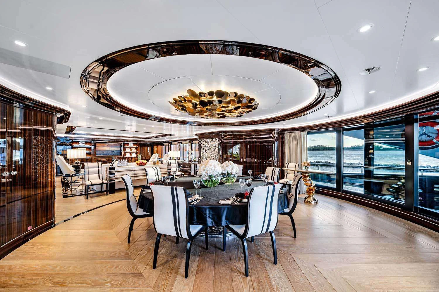 a large dining room with a chandelier aboard OKTO Yacht for Charter