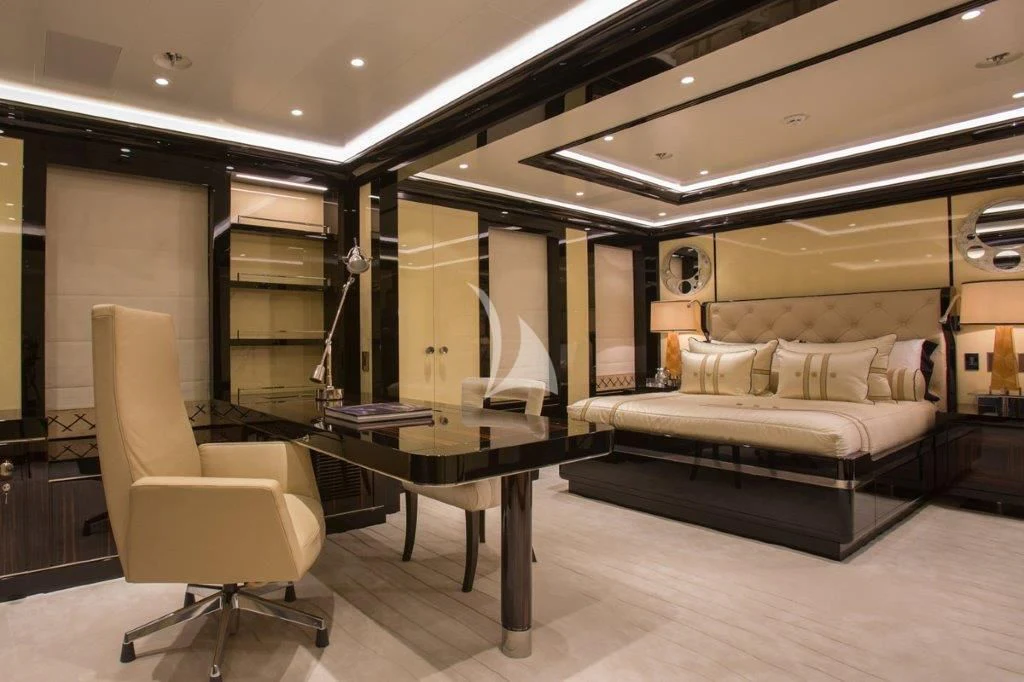 a room with a bed and a desk aboard OKTO Yacht for Charter
