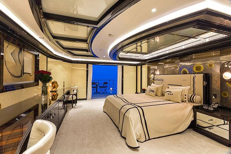 a room with a bed and a chair aboard OKTO Yacht for Charter