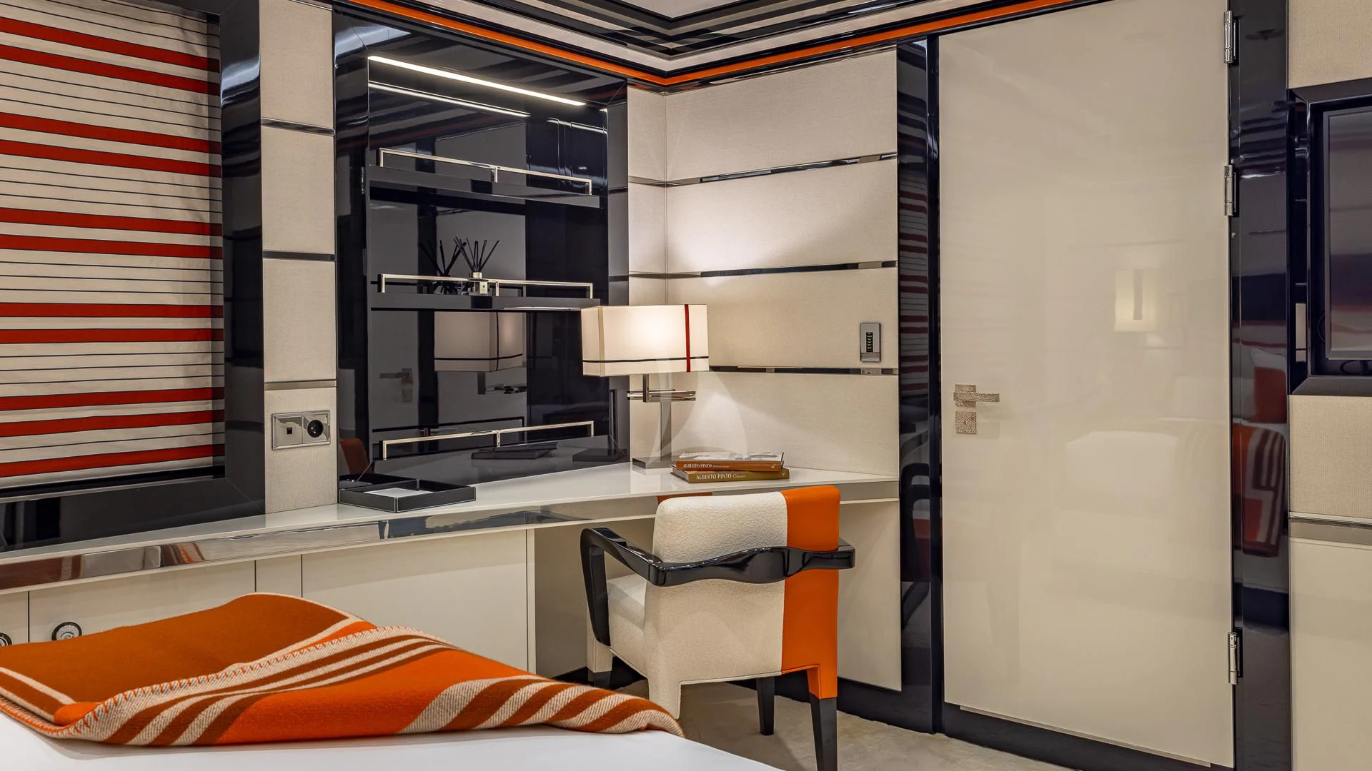 a room with a desk and a bed aboard OKTO Yacht for Charter