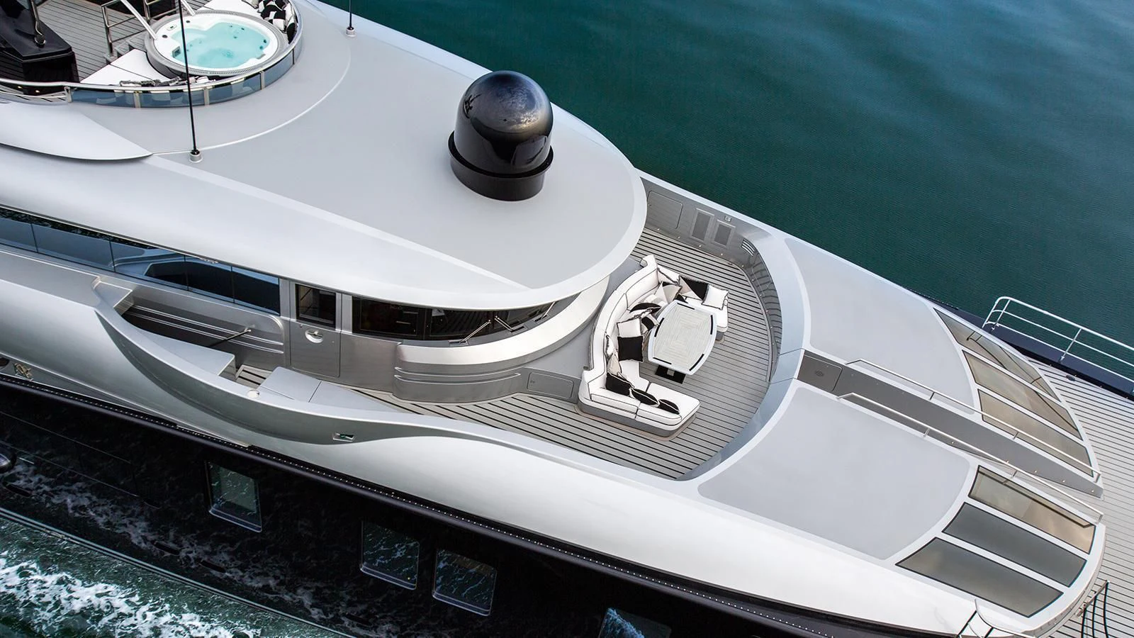 a white boat on a body of water aboard OKTO Yacht for Charter