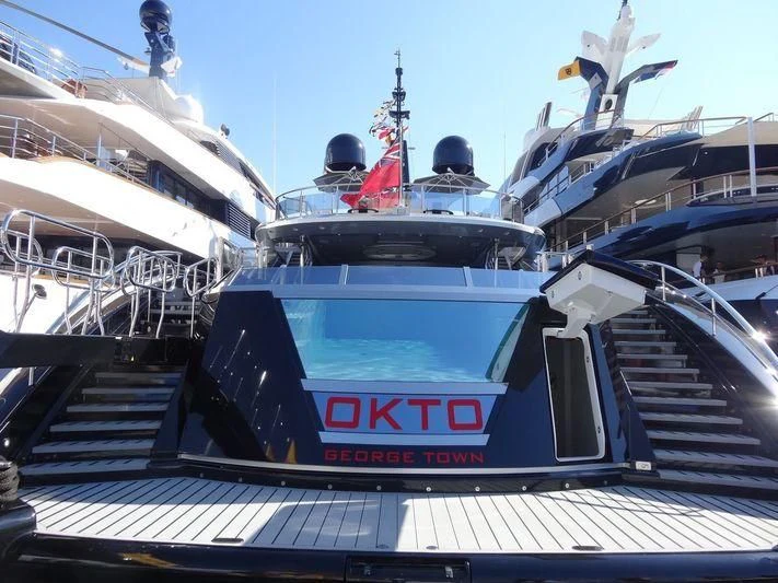 a large boat on a dock aboard OKTO Yacht for Charter