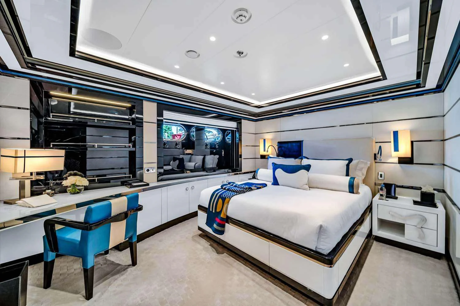 a room with a bed and desk aboard OKTO Yacht for Charter