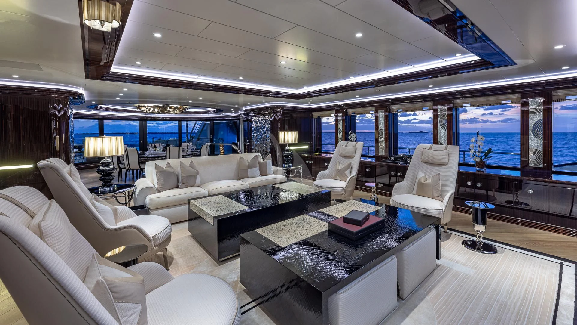 a room with a couch and a table and a tv aboard OKTO Yacht for Charter