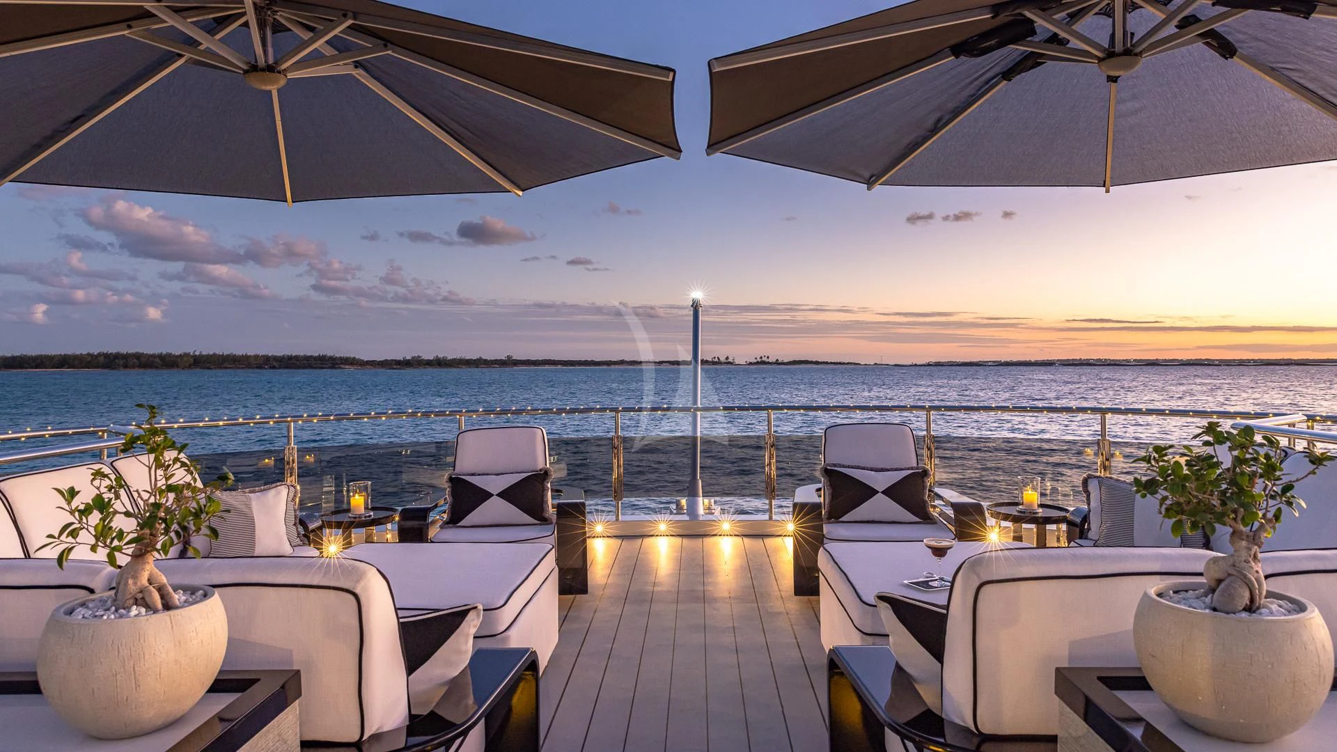 a deck with a view of the ocean and the ocean aboard OKTO Yacht for Charter
