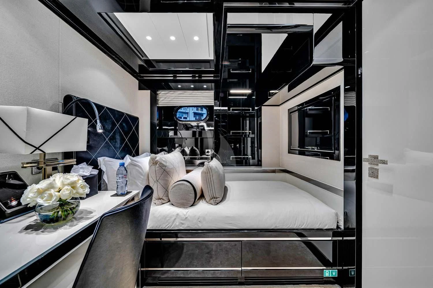 a room with a bed and a table aboard OKTO Yacht for Charter