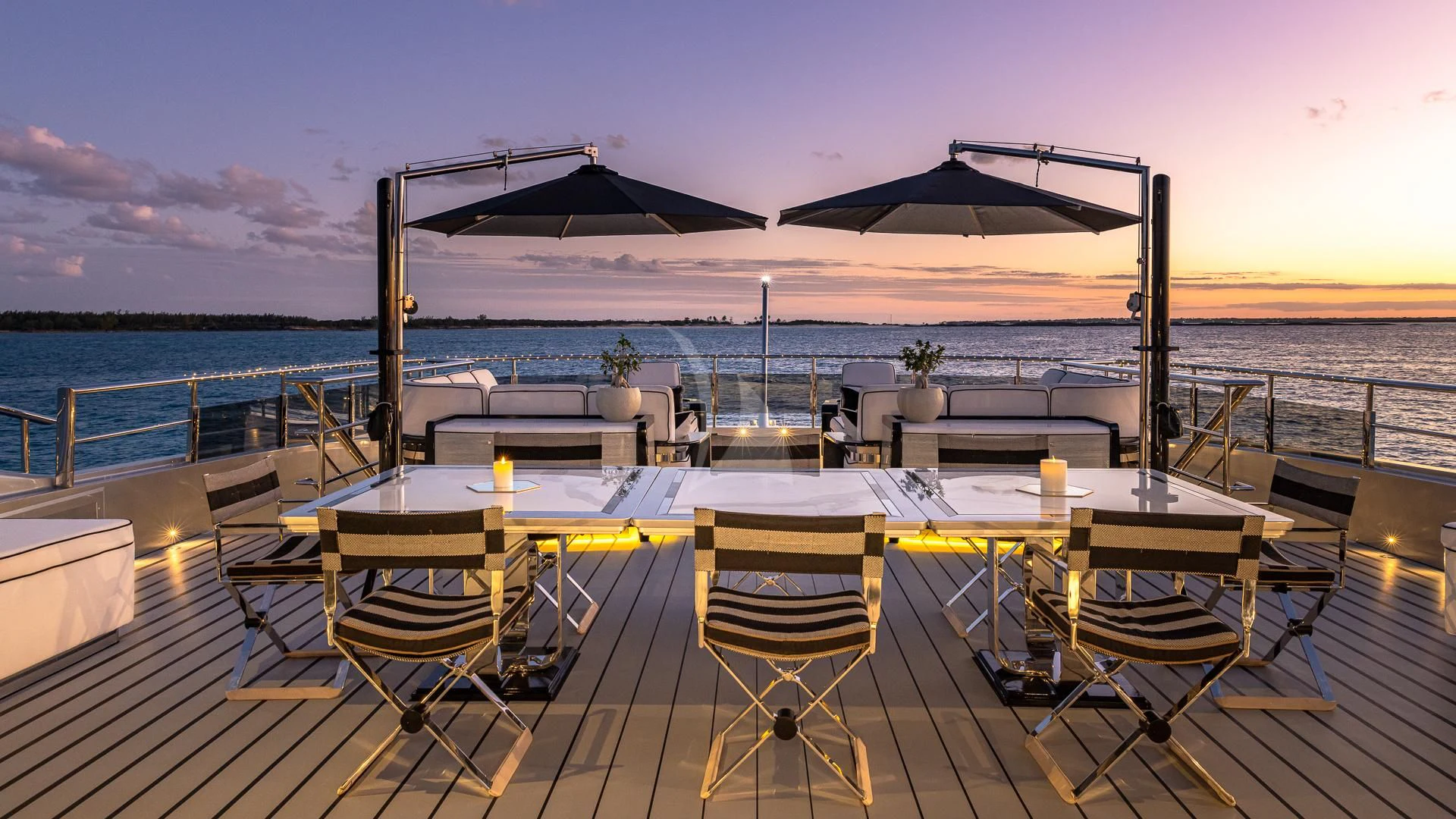 a table on a deck overlooking the ocean aboard OKTO Yacht for Charter