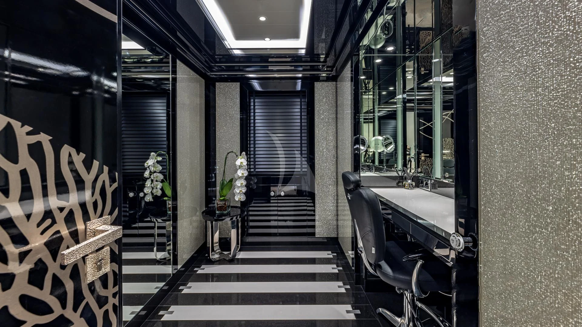 a hallway with a black and white striped staircase and a black door aboard OKTO Yacht for Charter