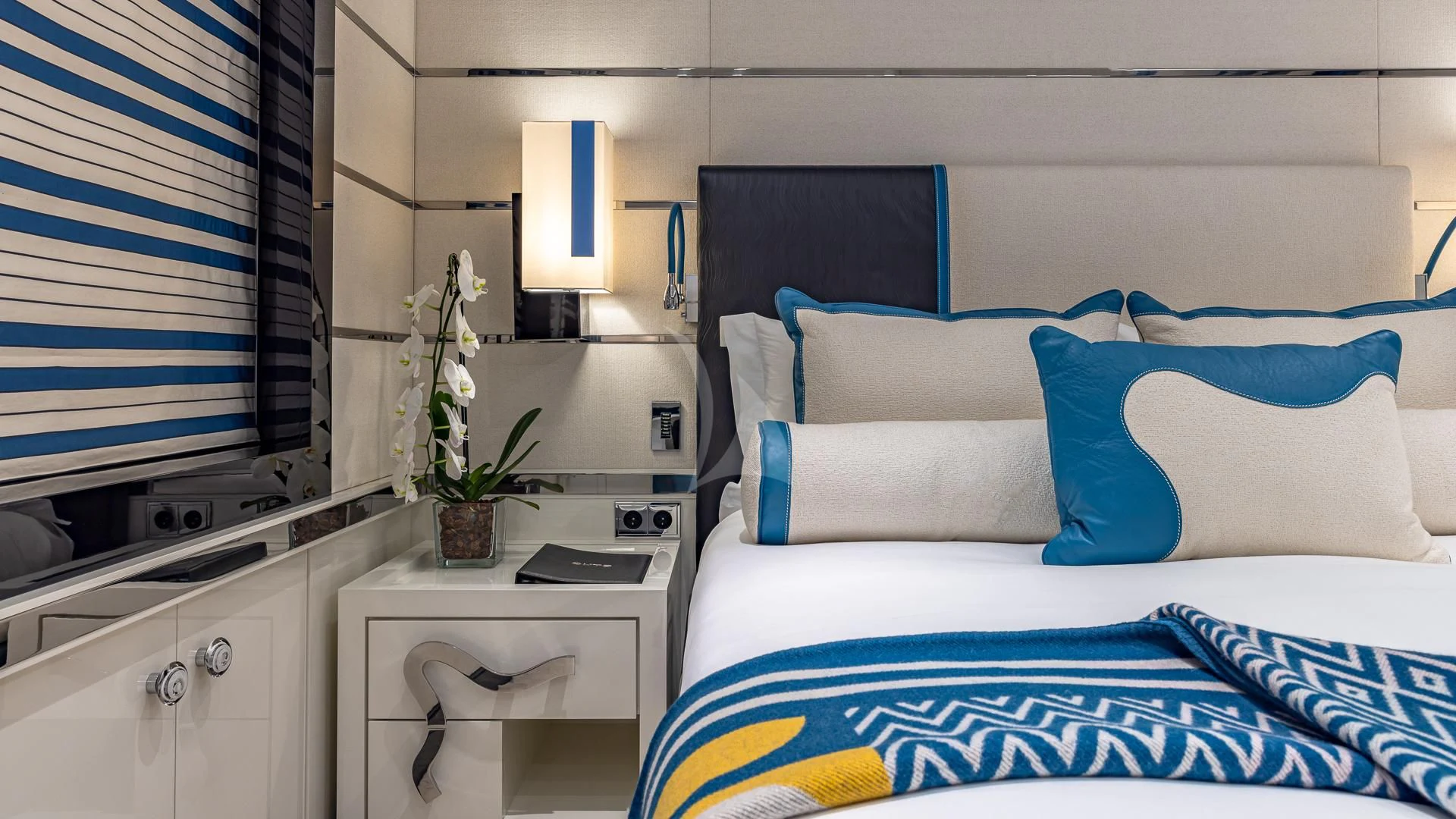 a bedroom with a bed and a desk aboard OKTO Yacht for Charter