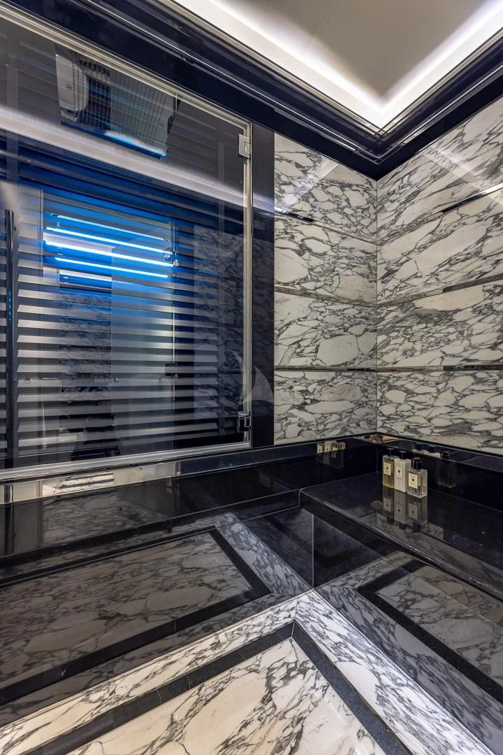 a room with a stone wall and a window aboard OKTO Yacht for Charter