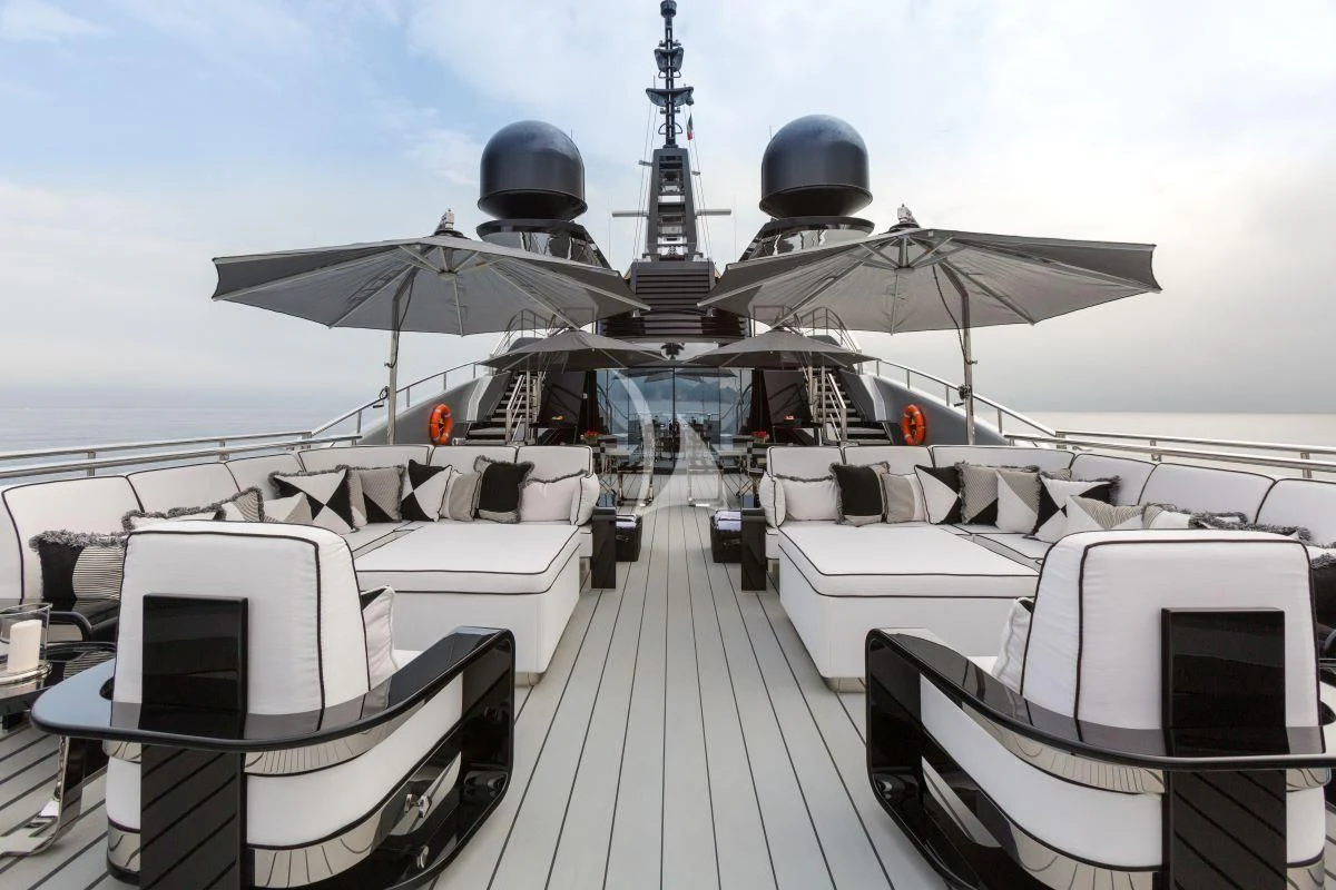 a deck with a deck and a boat on it aboard OKTO Yacht for Charter