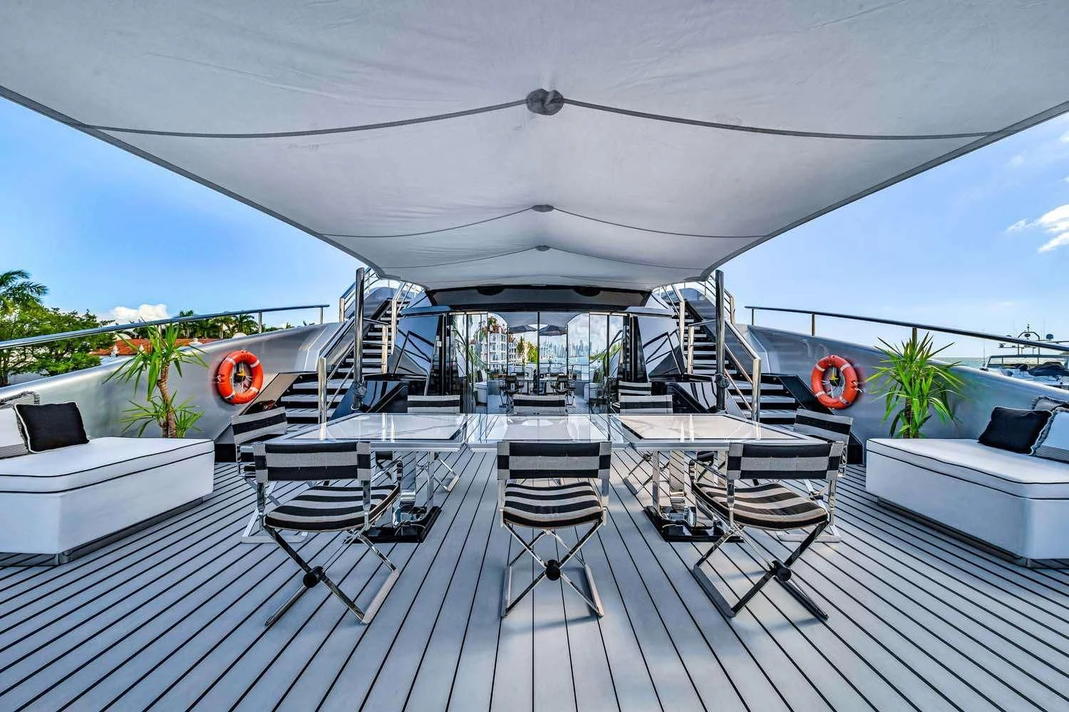 a deck with a chair and a table on it aboard OKTO Yacht for Charter
