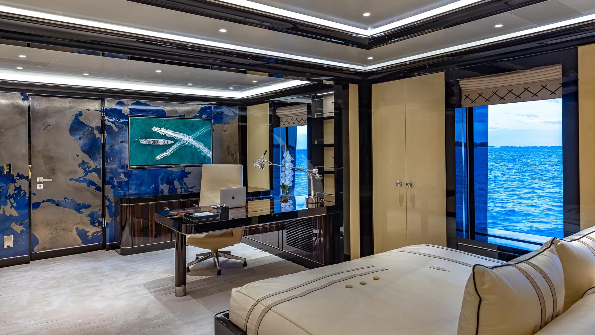 a room with a bed and desk aboard OKTO Yacht for Charter