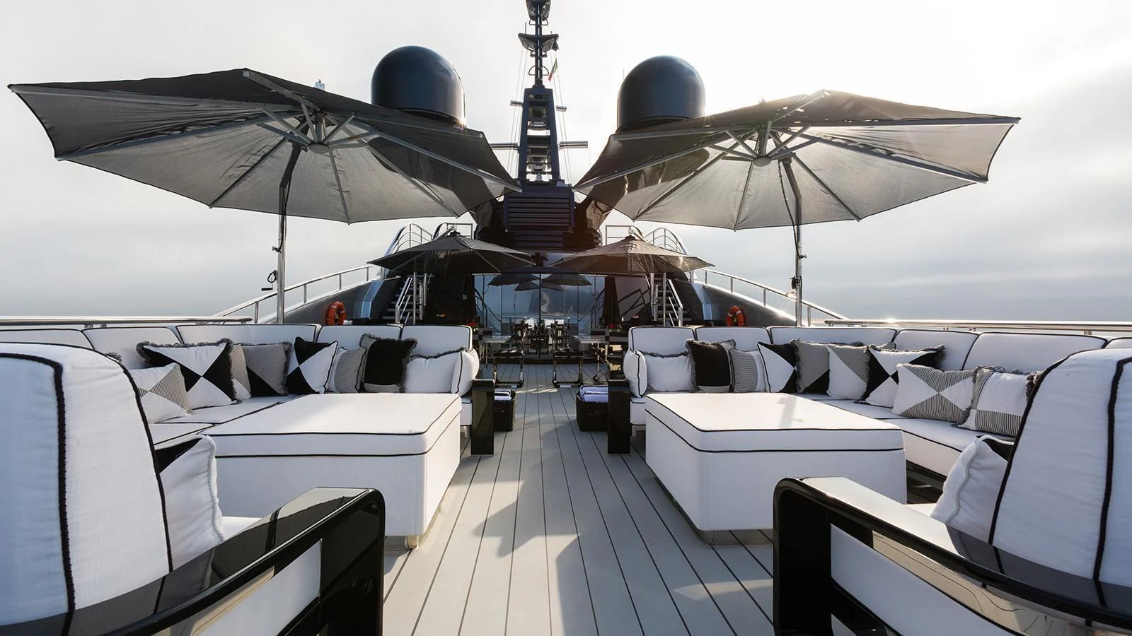 a boat with many white tables and chairs on a deck aboard OKTO Yacht for Charter