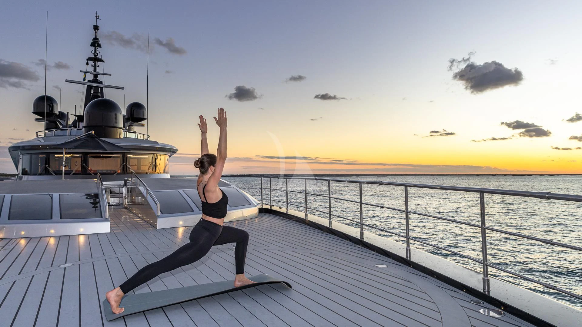 a person doing yoga on a deck aboard OKTO Yacht for Charter
