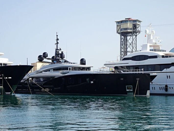 a couple of large boats in the water aboard OKTO Yacht for Charter